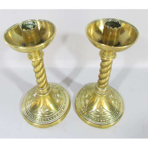 450 - A pair of Victorian brass candlesticks with spiral stem and splayed circular base, 19cm high.