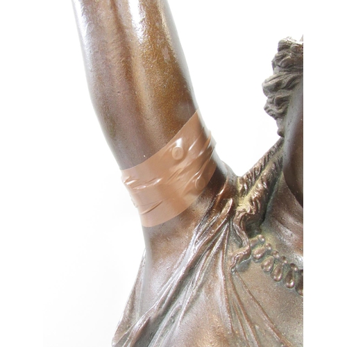 451 - A bronzed metal table lamp in the form of a classical woman holding aloft a lamp, raised on a circul... 