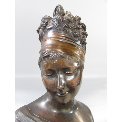 453 - A bronzed bust of a flirtatious woman raised on a marble plinth, bearing a small plaque Mme- Reeamie... 