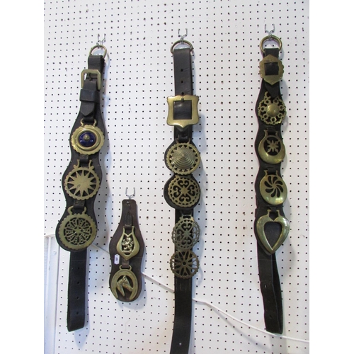 472 - Four 19th century  leather horse straps decorated with brasses and  ten loose horse brasses, togethe... 