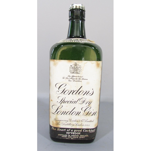 477 - An old bottle 70% Gordon’s Gin still with its original secure metal flip off cap.