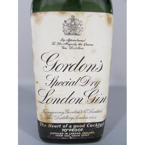 477 - An old bottle 70% Gordon’s Gin still with its original secure metal flip off cap.