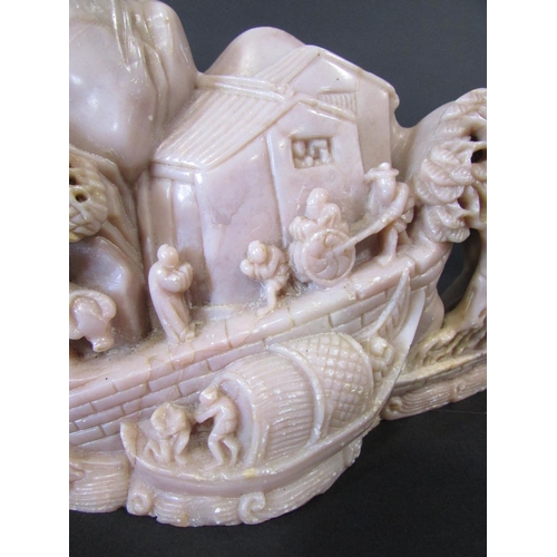 478 - Two Chinese soapstone carvings, on a pinkish colour of people and buildings on a hillside, the other... 