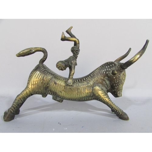 479 - A brass Minoan Bull Leaping Study, a man somersaulting over a bull’s back, 20cm long