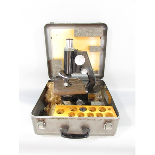 491 - A mid 20th century W Watson & Sons Ltd Service II microscope serial No 109601, with a metal carry ca... 