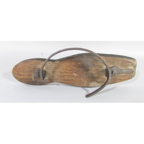 500 - A pair of 18th century iron and wood mud boots, lacking leather straps, (one as found) 25cm long.