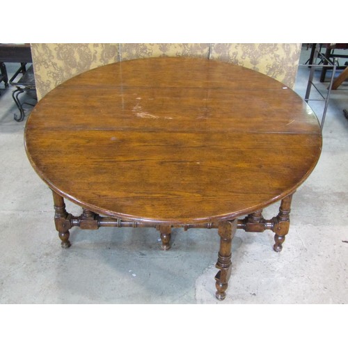 1324 - A large good quality reproduction oak gateleg dining (to seat 12) / wake table, 76 cm high, 205 x 14... 