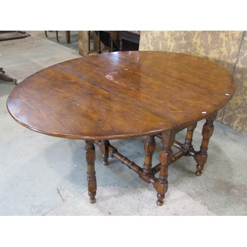 1324 - A large good quality reproduction oak gateleg dining (to seat 12) / wake table, 76 cm high, 205 x 14... 