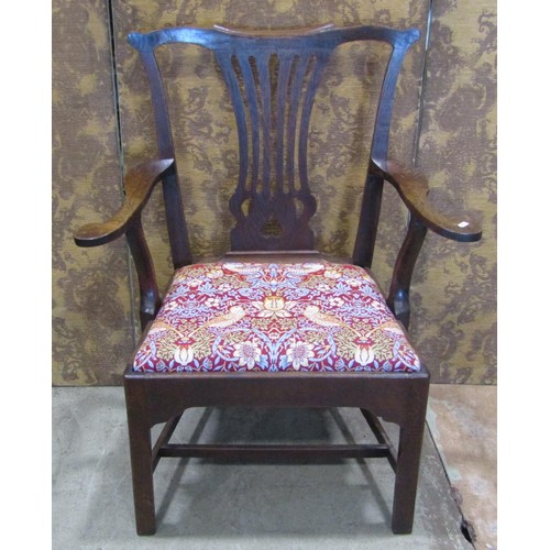 1326 - A Georgian oak elbow chair with pierced slat back and upholstered drop-in seat decorated with Willia... 