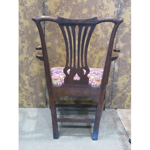 1326 - A Georgian oak elbow chair with pierced slat back and upholstered drop-in seat decorated with Willia... 