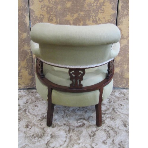 1335 - An Edwardian mahogany tub chair in green buttoned covers.