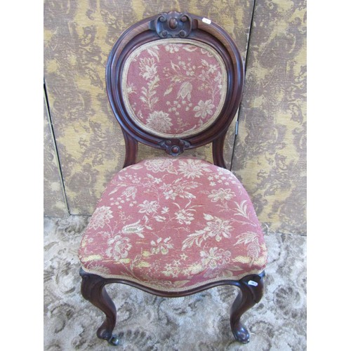 1343 - A set of four Victorian mahogany dining chairs with circular cartouche backs and serpentine seats ra... 