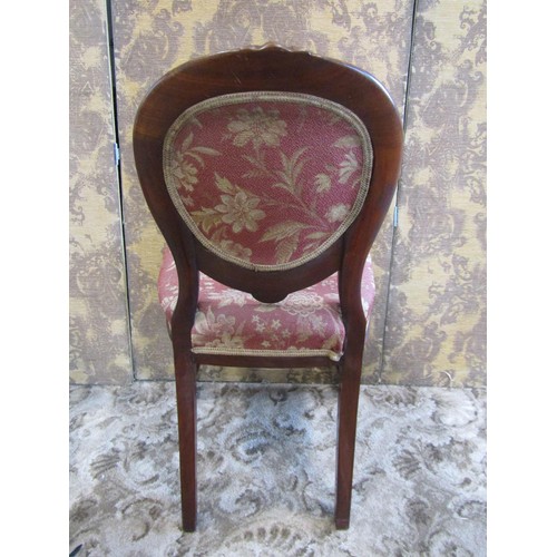 1343 - A set of four Victorian mahogany dining chairs with circular cartouche backs and serpentine seats ra... 