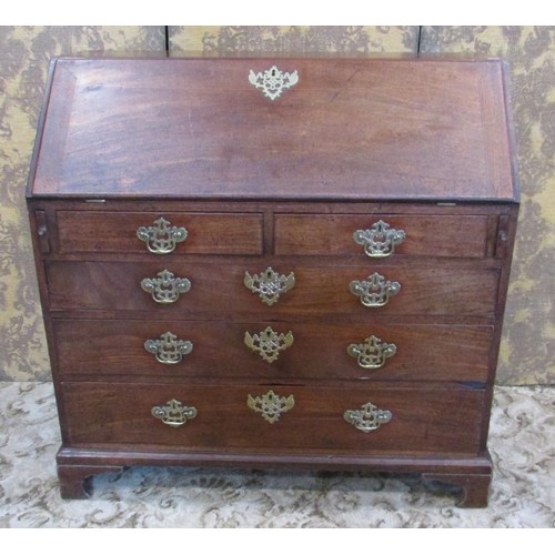 1345 - A George III mahogany bureau, fitted with a divisional interior over two short and three graduating ... 