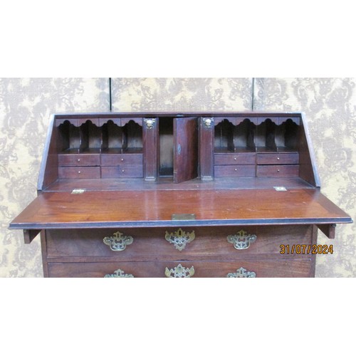 1345 - A George III mahogany bureau, fitted with a divisional interior over two short and three graduating ... 