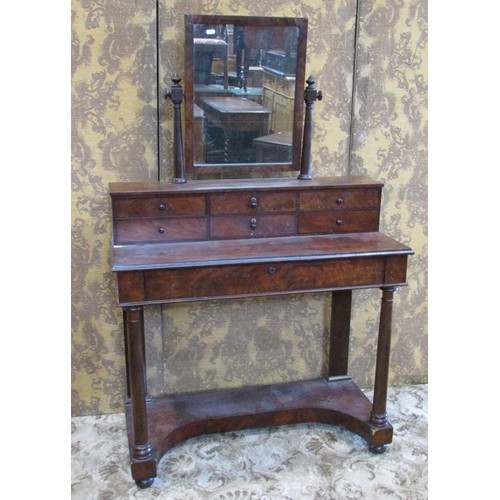 1349 - A Victorian flamed mahogany dressing table, with mirror flanked by tapering column supports over an ... 