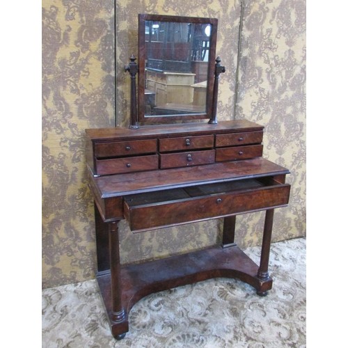 1349 - A Victorian flamed mahogany dressing table, with mirror flanked by tapering column supports over an ... 