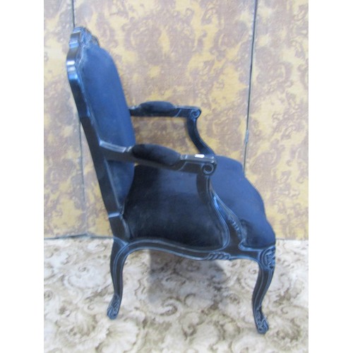 1353 - A reproduction black framed carved upholstered elbow chair together with an associated bedside cupbo... 