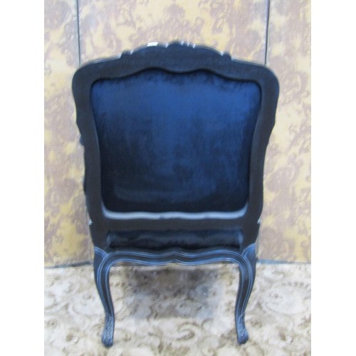 1353 - A reproduction black framed carved upholstered elbow chair together with an associated bedside cupbo... 