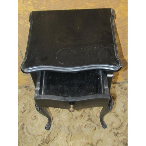 1353 - A reproduction black framed carved upholstered elbow chair together with an associated bedside cupbo... 