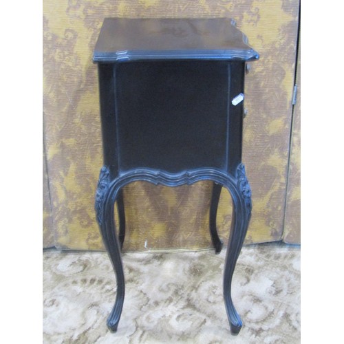 1353 - A reproduction black framed carved upholstered elbow chair together with an associated bedside cupbo... 