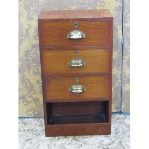 1354 - A small campaign style mahogany bank of three drawers with brass handles, 69cm high, 38 x 23cm.