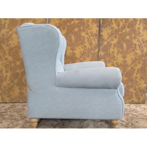 1362 - A large good quality upholstered armchair with buttoned back and rolled arms, raised on pale oak leg... 