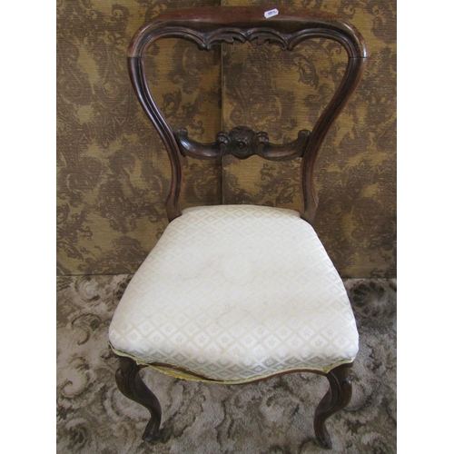 1364 - A pair of Victorian rosewood balloon-back chairs, with fixed upholstered seats in pale lemon covers.