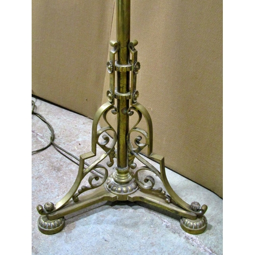 1374 - An Edwardian brass floor-standing standard lamp with scrolled mounts, 125cm high