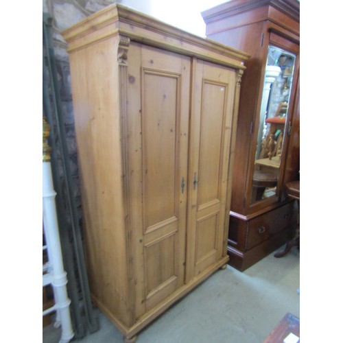 1376 - A small stripped pale pine double wardrobe, 170cm high, 110 x 53.