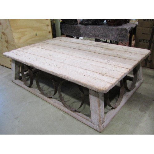 1391 - A large, low, rustic bleached pine coffee / occasional table, with planked top over banded strap wor... 