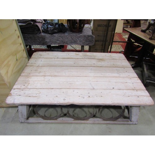 1391 - A large, low, rustic bleached pine coffee / occasional table, with planked top over banded strap wor... 