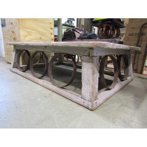 1391 - A large, low, rustic bleached pine coffee / occasional table, with planked top over banded strap wor... 