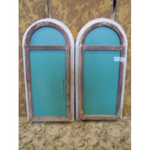 1392 - A pair of reclaimed pine arched window frames adapted as wall mirrors, with rustic pale blue painted... 