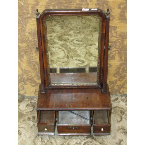 1395 - A small late 18th century mahogany dressing mirror, the base fitted with three drawers with turned b... 