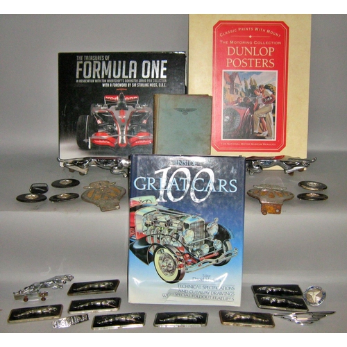 538 - Car memorabilia, mainly Jaguar car badges and logos, together with racing car related books.