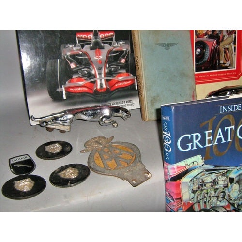 538 - Car memorabilia, mainly Jaguar car badges and logos, together with racing car related books.