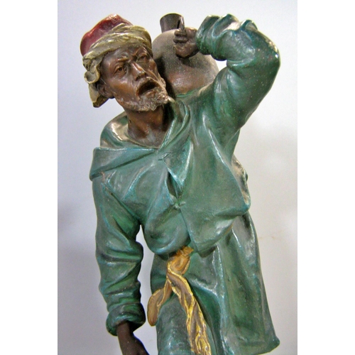 542 - A painted spelter figure of an Arab water carrier climbing cobbled steps, signed Henry Weisse to sid... 