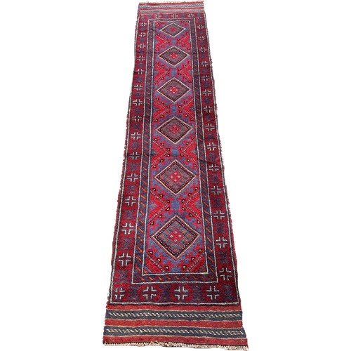 1752 - A Meshwani runner with a repeating red and blue diamond pattern 253cm x 57cm