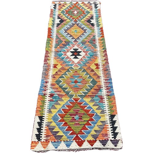 1756 - A Chobi kilim runner with a central row of stepped medallions   195cm x 63cm