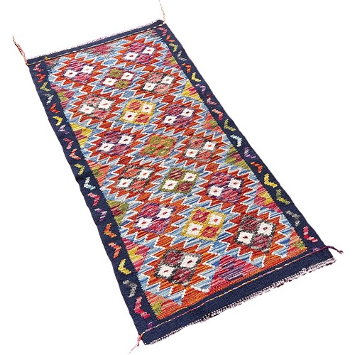 1760 - A Chobi kilim runner with three rows of stepped diamonds 134cm x64cm approximately