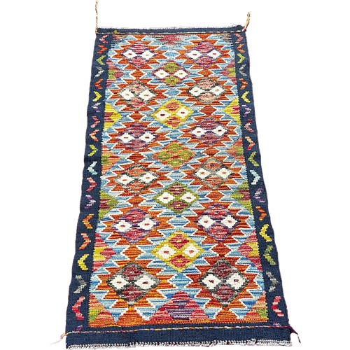 1760 - A Chobi kilim runner with three rows of stepped diamonds 134cm x64cm approximately