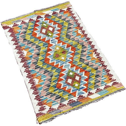 1776 - A Chobi kilim mat with a central row of three diamonds 97cm x 64cm