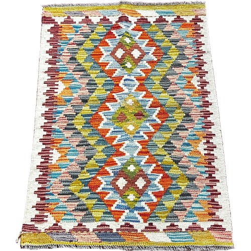 1776 - A Chobi kilim mat with a central row of three diamonds 97cm x 64cm