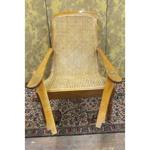 1445 - A bergere caned plantation chair with extending arms