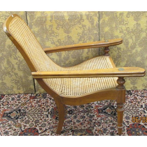 1445 - A bergere caned plantation chair with extending arms