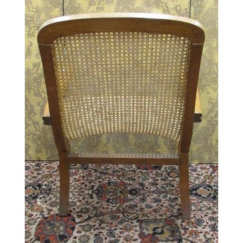 1445 - A bergere caned plantation chair with extending arms