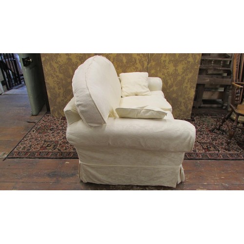 1450 - A contemporary two-seat sofa with loose cream covers