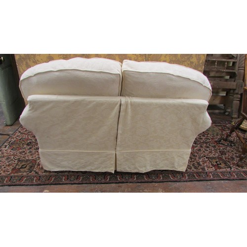 1450 - A contemporary two-seat sofa with loose cream covers