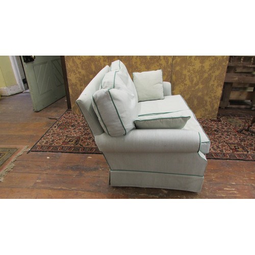 1451 - A contemporary two-seat settee with cream and green stripped covers and green stripped borders.